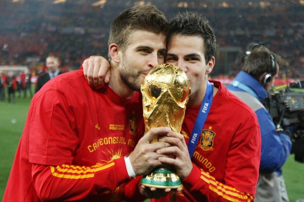 Pique and Fabregas with World Cup trophy